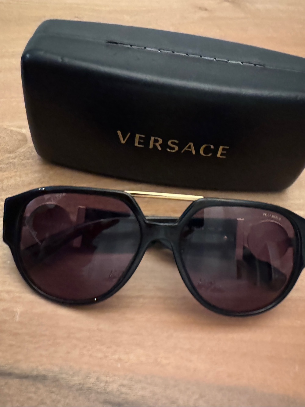 Versace Black Frame Sunglasses with Gold Brow Bar and Burgundy Lenses
